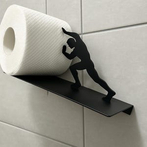 Porta carta igienica da parete Hercules – Mensola in metallo nero per riporre gli oggetti in bagno – Divertente dispenser per rotoli Strongman