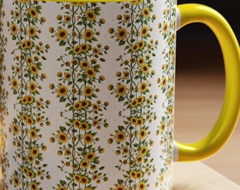Taza de café con estampado de girasoles y asa interior amarilla.