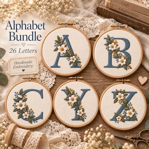 May include: Five circular wooden embroidery hoops featuring the letters A, B, C, Y, and Z stitched in blue thread, decorated with white and yellow floral embroidery. The text Alphabet Bundle 26 Letters and Handmade Embroidery is visible.