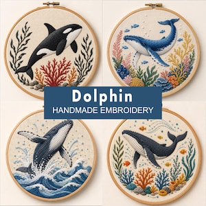 May include: Four circular wooden embroidery hoops featuring marine life designs. The top left shows an orca, the top right a blue whale, the bottom left a breaching whale, and the bottom right a whale with coral. Text reads: Dolphin HANDMADE EMBROIDERY.
