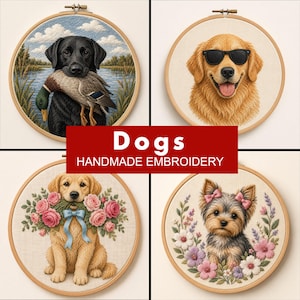 May include: Four circular wooden embroidery hoops featuring dog designs. One shows a black Labrador with a duck, one a Golden Retriever with sunglasses, one a Golden Retriever with pink roses and a blue bow, and one a Yorkshire Terrier with flowers.