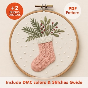 May include: A cross-stitch embroidery hoop featuring a pink knitted stocking design filled with green foliage and red berries. The text "+2 BONUS DESIGNS" and "PDF Pattern" are visible. The text "Include DMC colors & Stitches Guide" is also included.