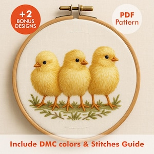 May include: Embroidery hoop featuring three fluffy yellow chicks with orange beaks and legs, standing on green grass. The design is set against a cream-colored fabric. Text includes "+2 BONUS DESIGNS" and "PDF Pattern". The text "Include DMC colors & Stitches Guide" is also present.