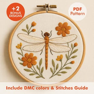 May include: Embroidered dragonfly and floral design in a wooden hoop. The dragonfly is beige with orange accents, surrounded by orange flowers and green leaves. Text includes "+2 Bonus Designs" and "PDF Pattern". The text "Include DMC colors & Stitches Guide" is also present.
