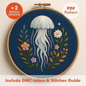 May include: Embroidered hoop art featuring a jellyfish design. The jellyfish is light blue and white, with long flowing tentacles. The design includes flowers and foliage in shades of pink, yellow, and green, set against a dark blue background. The text "+2 BONUS DESIGNS" and "PDF Pattern" are visible.