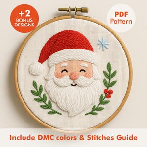 May include: A Santa Claus embroidery design in a wooden hoop. Santa has a red hat, white beard, and rosy cheeks. Green leaves and red berries surround Santa. The text "+2 BONUS DESIGNS" and "PDF Pattern" are visible.