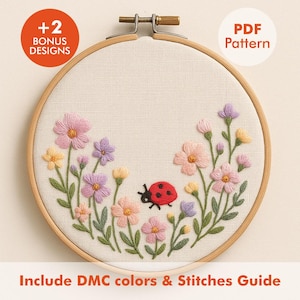 May include: Embroidered floral design in a wooden hoop. The design features pink, purple, and yellow flowers with green stems and leaves, and a red ladybug. Text includes "+2 Bonus Designs", "PDF Pattern", and "Include DMC colors & Stitches Guide".