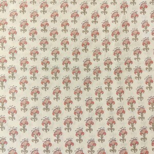 May include: White fabric with a repeating pattern of small pink and green flowers.
