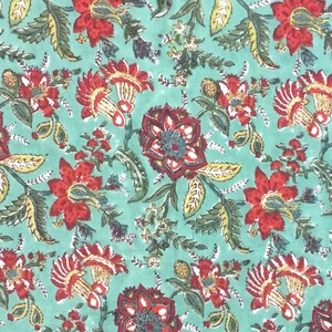 May include: A teal fabric with a repeating floral pattern. The flowers are red, yellow, and green. The fabric has a vintage look.