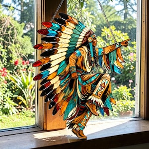 May include: A stained glass panel depicting a Native American figure in traditional dress, with a feathered headdress and detailed design. The figure is in a dynamic pose, with vibrant blues, oranges, and browns. The artwork is suspended by a chain, likely for display.