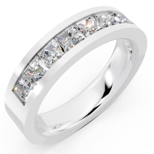 May include: A white metal ring with a channel setting, showcasing a row of square-cut, clear gemstones. The ring's band is smooth and polished, reflecting light. The gemstones are evenly spaced, creating a continuous sparkle.