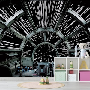 May include: A Star Wars-themed wall mural depicting the interior of the Millennium Falcon cockpit with a view of hyperspace. A white shelf unit holds toys and decorative boxes. A stuffed bunny sits on top of the shelf.