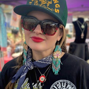 May include: A distressed wooden sign with the words "Welcome to our home" in white lettering. The sign has a rustic finish and a simple design, ideal for a front door or hallway.