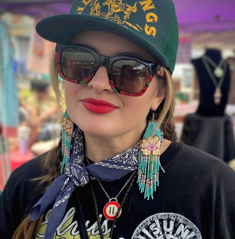 May include: A distressed wooden sign with the words "Welcome to our home" in white lettering. The sign has a rustic finish and a simple design, ideal for a front door or hallway.