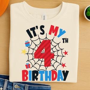 May include: Cream-colored t-shirt with the text "IT'S MY 4TH BIRTHDAY" in a colorful design. The number 4 is red, surrounded by a spiderweb graphic. Includes gift and star illustrations.