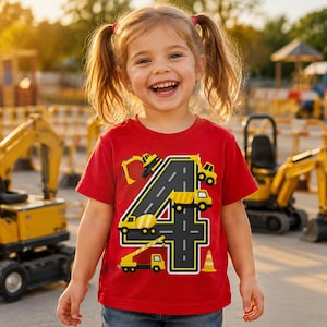 May include: A bright red short-sleeved t-shirt featuring a large graphic of the number four designed to look like a paved road. The number is surrounded by yellow construction vehicles including excavators, a dump truck, and a traffic cone.