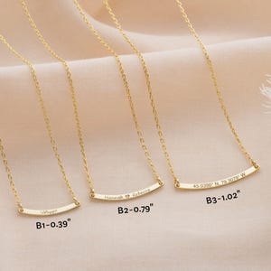 May include: Gold-colored necklaces with delicate chains and curved bar pendants. Each pendant is engraved with a name or coordinates, and the bar lengths are indicated in inches: 0.39", 0.79", and 1.02".
