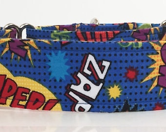 May include: A blue dog collar with a comic book print featuring words like "Super", "Zap", and "Wow" in colorful speech bubbles.