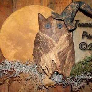 May include: A brown owl with a witch's hat, with a full moon in the background. The owl has large black eyes and a rustic, primitive style. The text "Tennessee Ridge Primitives ©2008" is visible in the image.
