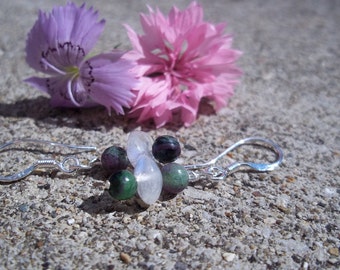 May include: Silver earrings with a cluster of green, purple, and white gemstone beads.