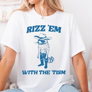 Rizz ’Em With The ’Tism Shirt | Cowboy Raccoon Meme Tee | Funny Autism Shirt | Western Humor Gift | Unisex Graphic Tee | Raccoon T-Shirt