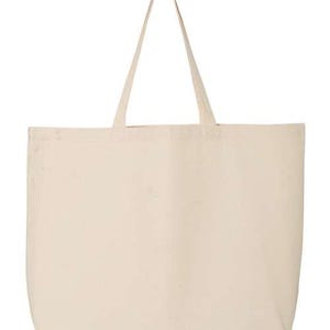 May include: A large, cream-colored tote bag with long handles. The bag is rectangular with rounded corners and a simple, minimalist design. The handles are made of the same material as the bag and are attached at the top.