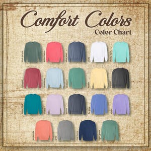 May include: A colour chart showcasing Comfort Colors sweatshirts in a range of hues. The chart presents sweatshirts in shades such as blue spruce, watermelon, and true navy. The text "Comfort Colors" and "Color Chart" are displayed at the top.