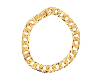 May include: A gold-colored bracelet with a textured, chain-link design. The bracelet features a secure clasp and is displayed against a white background. The jewelry piece is a classic accessory.