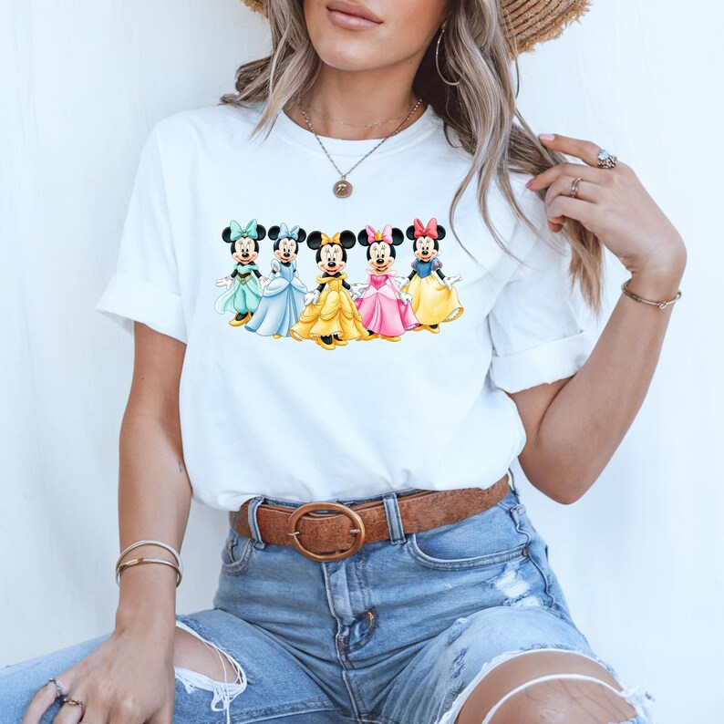 May include: A white ceramic mug with a black handle and the text "But First, Coffee" in a bold, black font. The mug is set against a neutral background, highlighting its simple design.