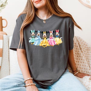 May include: A white ceramic mug with a black handle and the text "But First, Coffee" in a black, handwritten-style font. The mug is likely 11-15 ounces, suitable for hot beverages.