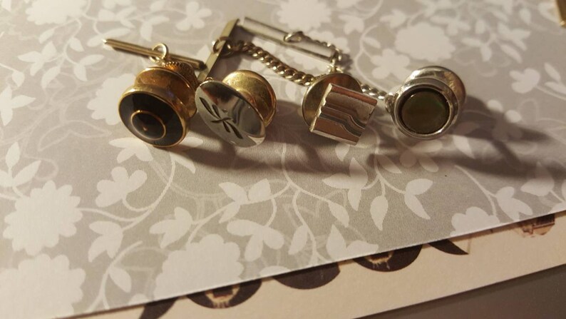 Eleven men/'s tie tacks all in a row