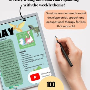 May include: A digital tablet displaying a colorful page from a dinosaur-themed activity book for toddlers. The page features a dinosaur illustration and the text "Dinosaur Dance!" The page also includes a list of materials needed for the activity, such as bread, heavy books, and gummy candies. The text "We are the Dinosaurs" is also visible on the page. The tablet is on a white surface with a hand holding a black stylus.