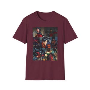 May include: A maroon short-sleeve t-shirt featuring a graphic print of a comic book panel collage. The artwork displays various scenes of a dark-haired character in a red, black, and yellow costume, including action poses and close-up portraits.