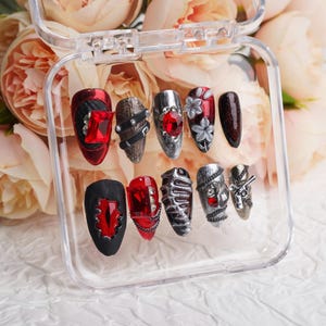 The Love and Deepspace Sylus， Paired with black and gray accents and silver petals adorned with red gemstones,  definitely worth collecting