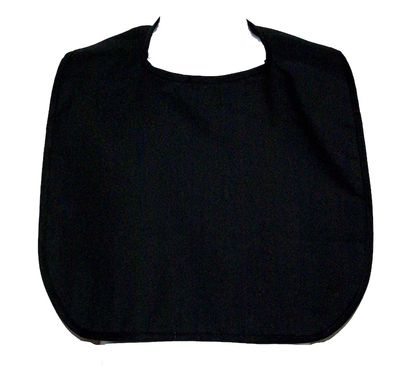 May include: A solid black bib with a rounded bottom and a curved neckline. The bib is made of a soft, textured fabric and is designed to protect clothing from spills and stains. The shape is a simple, functional design.