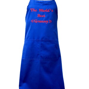 May include: A blue apron with a red embroidered message that reads "The World's Best Granny" with two hearts.