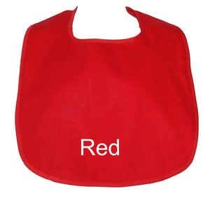 May include: Red fabric baby bib with a rounded neckline and a white "Red" text on the front.