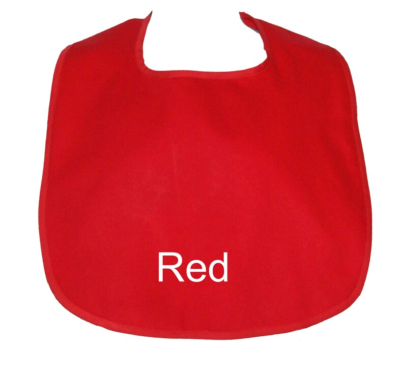 May include: Red fabric baby bib with a rounded neckline and a white "Red" text on the front.