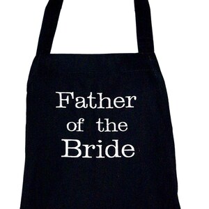 May include: Black apron with white text that reads "Father of the Bride".