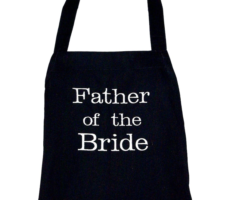 May include: Black apron with white text that reads "Father of the Bride".