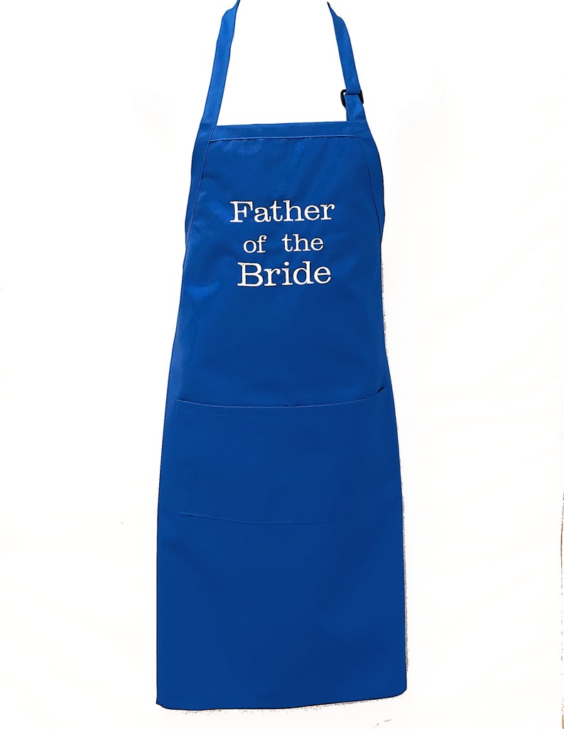 May include: Royal blue apron with a large pocket and adjustable straps. The apron is embroidered with the text "Father of the Bride" in white.