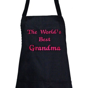 May include: Black apron with adjustable straps and a large pocket. The apron has pink embroidery that reads "The World's Best Grandma".