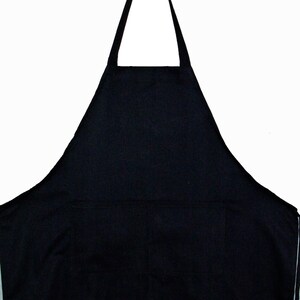 May include: A black apron with adjustable straps and a large pocket. The apron is made of a durable, water-resistant fabric.
