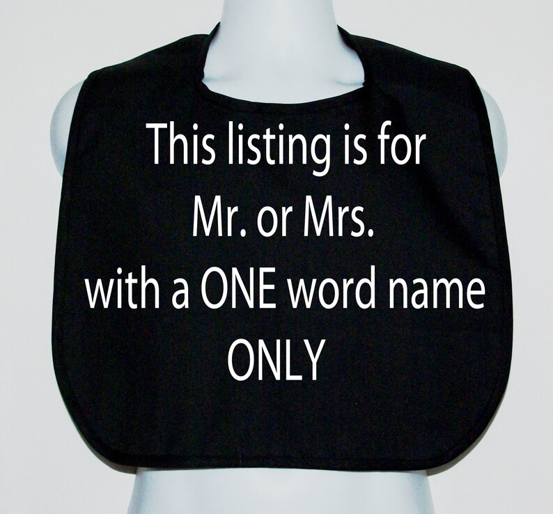 May include: Black baby bib with white text that reads: "This listing is for Mr. or Mrs. with a ONE word name ONLY."