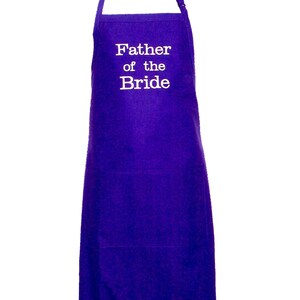 May include: Purple apron with a white pocket and the text "Father of the Bride" embroidered on the front.