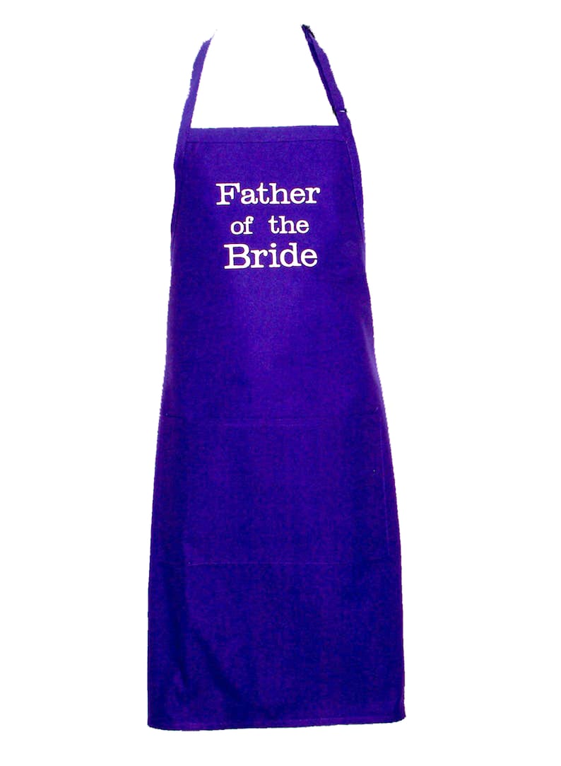 May include: Purple apron with a white pocket and the text "Father of the Bride" embroidered on the front.