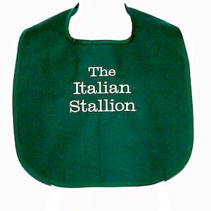 May include: A green bib with white embroidery that reads "The Italian Stallion".