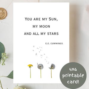 May include: A white greeting card featuring the black text: YOU ARE MY SUN, MY MOON AND ALL MY STARS, E.E. CUMMINGS. Below the text are three dandelion illustrations: one yellow flower, one white seed head, and one partially dispersed seed head.