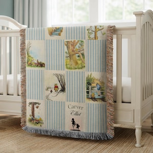 May include: A woven throw blanket featuring a grid of Winnie the Pooh illustrations separated by light blue and white vertical stripes. The blanket includes the printed text Carver Elliot and a silhouette of a child holding a balloon.