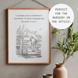 May include: A rectangular wall art print in a light wood frame featuring a black and white line drawing of Winnie the Pooh and Christopher Robin on a bridge. The text reads: IT MAKES SUCH A DIFFERENCE SAID POOH TO HAVE SOMEONE WHO BELIEVES IN YOU.